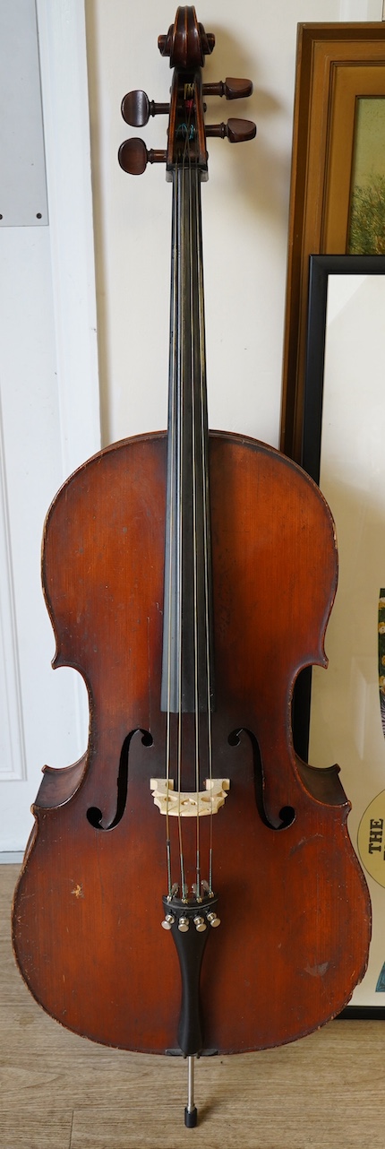 An early 19th century cello with a Stradivarius label, body 76cm, with a P&H bow, in a good modern case. Condition - poor